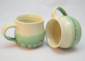 round green and white stoneware mugs