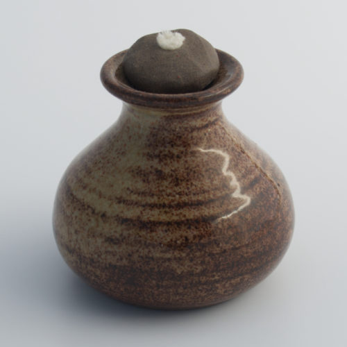 brown ceramic oil lamp