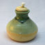 stoneware oil lamp with green glaze